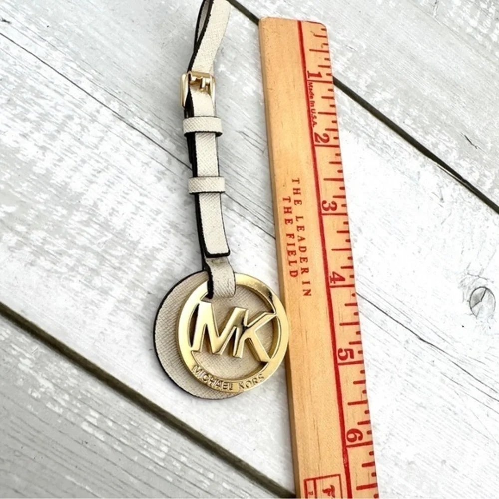Michael Kors handbag charm.